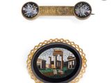 two pieces of brooches and a pin with a picture of a palace