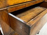 an old wooden desk with a drawer underneath it