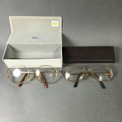 two pairs of glasses and a case on a table