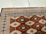a cat that is sitting on a rug on the floor