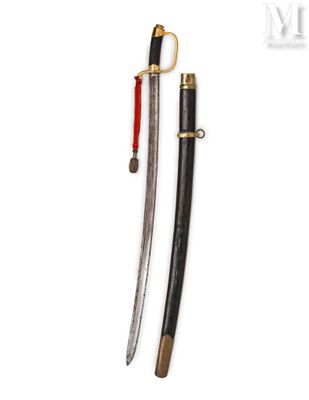 a pair of swords with a wooden handle and brass fittings