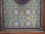 a picture of a stained glass window with a clock on it
