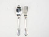 two spoons and a fork on a white table