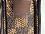 the inside of a louis vuitton purse with a tag on it