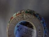 a close up of a vase with a tag on it