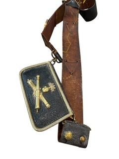 a cross and a book on a strap with a cross on it