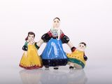 three figurines of a woman, a man and a child