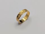 a gold ring with a pattern on the inside of it