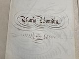 an old book sitting on top of a table with writing on it