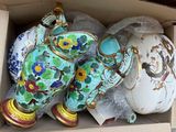 many vases in a box that are sitting on the floor