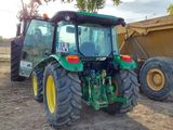 a tractor that is parked in the dirt