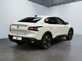 the rear end of a white suv parked in a garage