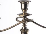 a silver candle holder with two candles on it