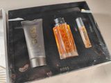 a bottle of perfume and a tube of lotion in a box