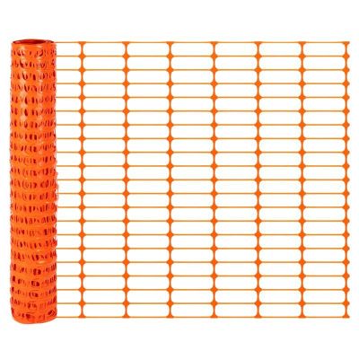 a roll of orange safety fence with a white background