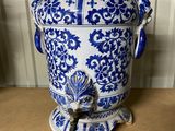 an old blue and white vase sitting on top of a wooden table