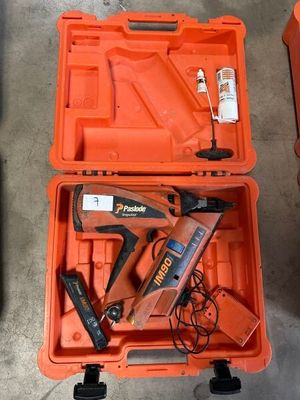 an orange tool case with tools in it sitting on the floor