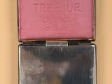 a small metal box with three different colored boxes on top of it