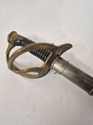 a sword that is laying on a white surface