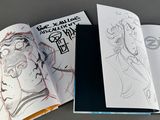 an open book with a drawing of a man and a woman