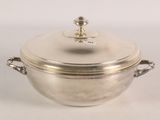 a silver pot with a lid on a white table