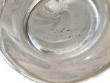 a glass bowl with a silver rim sitting on a table