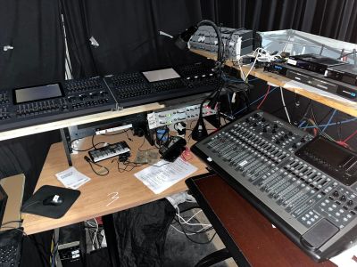 a desk with a computer, keyboard, monitor, mouse and other electronic equipment on it