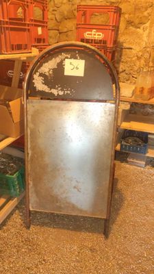 a large metal trash can sitting in the middle of a room