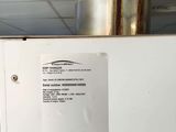 a white refrigerator with a sticker on it in a room