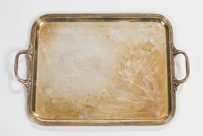an antique brass tray with handles and handles on a white surface