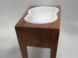 a white sink sitting on top of a wooden table