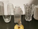 many glass vases sitting on a table next to each other