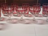 many wine glasses lined up on a white table