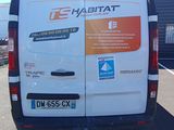 a white van parked in a parking lot next to a building