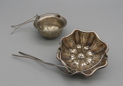 two silverware items including a bowl, spoon and spoon rest