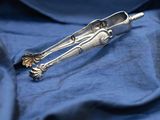 a silver spoon and spoon rest on a blue cloth