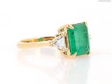 an image of a close up of a ring with an emerald stone