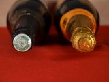 two bottles of wine that are sitting on a table