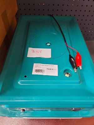 a blue plastic box with a red cord on top of it