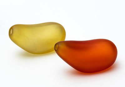 two pieces of glass sitting next to each other on a white surface