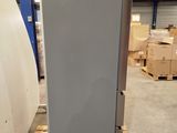 a refrigerator that is sitting on a pallet in a warehouse