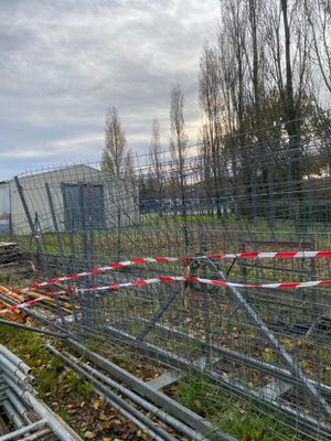 a fence that has been set up in front of a building