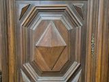 a close up of a wooden door with carvings on it