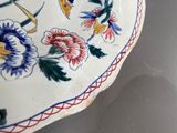 two plates that have flowers on them on a table