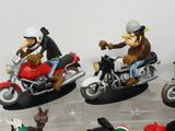 many figurines of people riding motorcycles on display