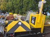 a yellow crane that is sitting on a pile of junk