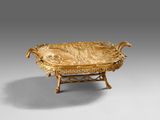 a gold plate with a fish on it on a stand