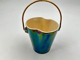 an image of a blue and green bucket with a gold handle