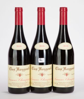 three bottles of red wine sitting next to each other on a white surface