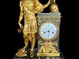 a statue of a man holding a clock on a pedestal